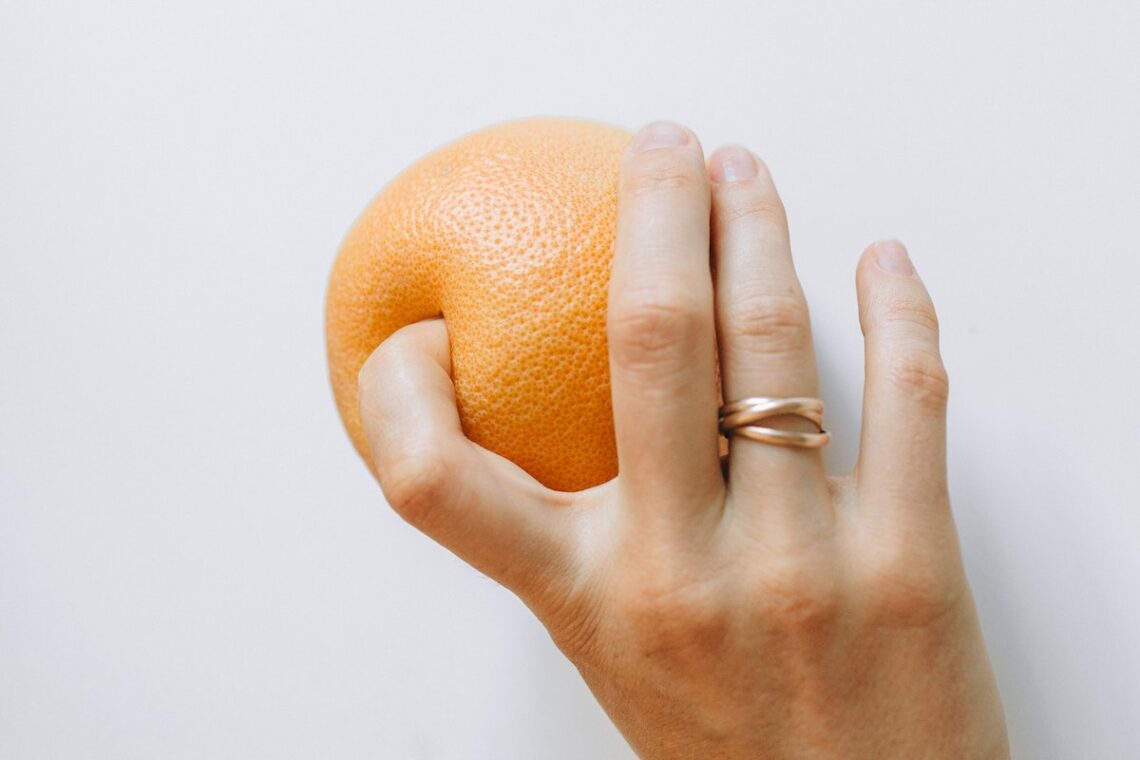 Person Holding Orange Fruit
