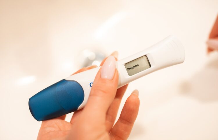 A Woman Hand Holding a Digital Pregnancy Test Kit