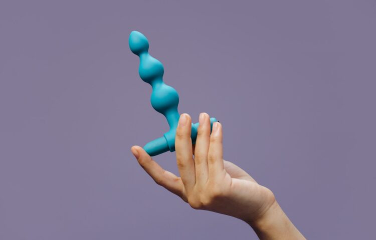 A Person Holding a Sex Toy